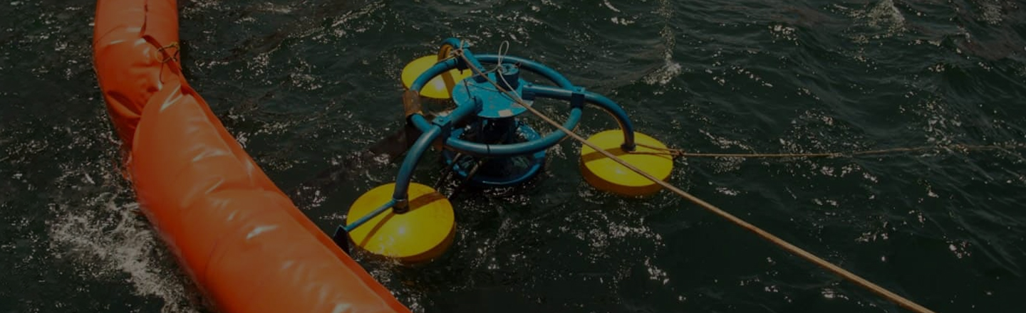 Weir skimmer operating beside containment boom