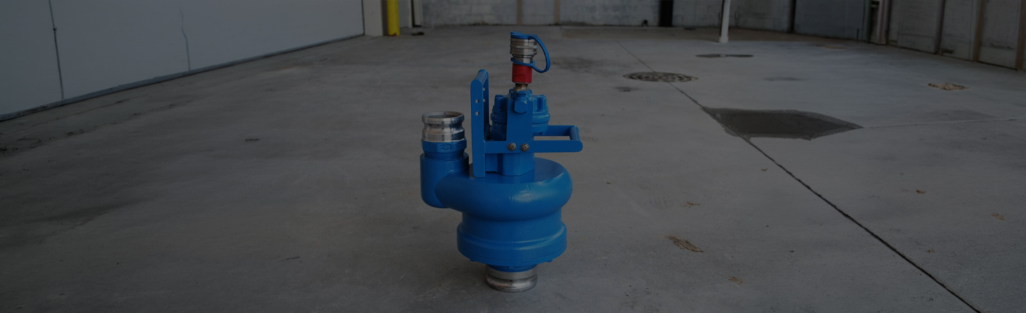 Blue pump header on a concrete warehouse floor