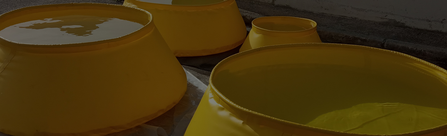 Yellow self-raising tanks in industrial setting