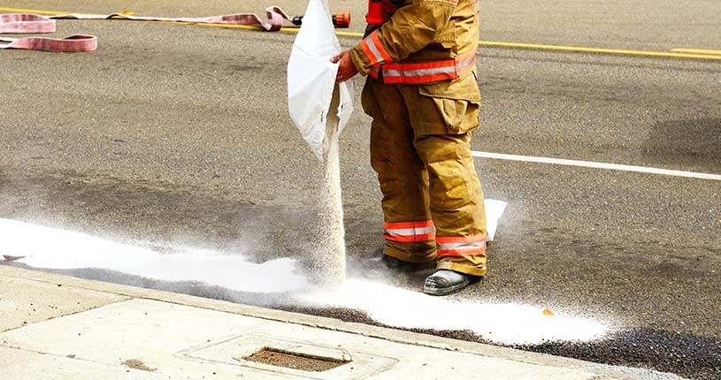 cleaning up oil spill on road